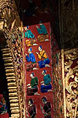 Wat Xieng Thong temple in Luang Prabang, Laos. the Ho Tai, the library. Colourful glass mosaics on a pink background with scenes of daily life. 